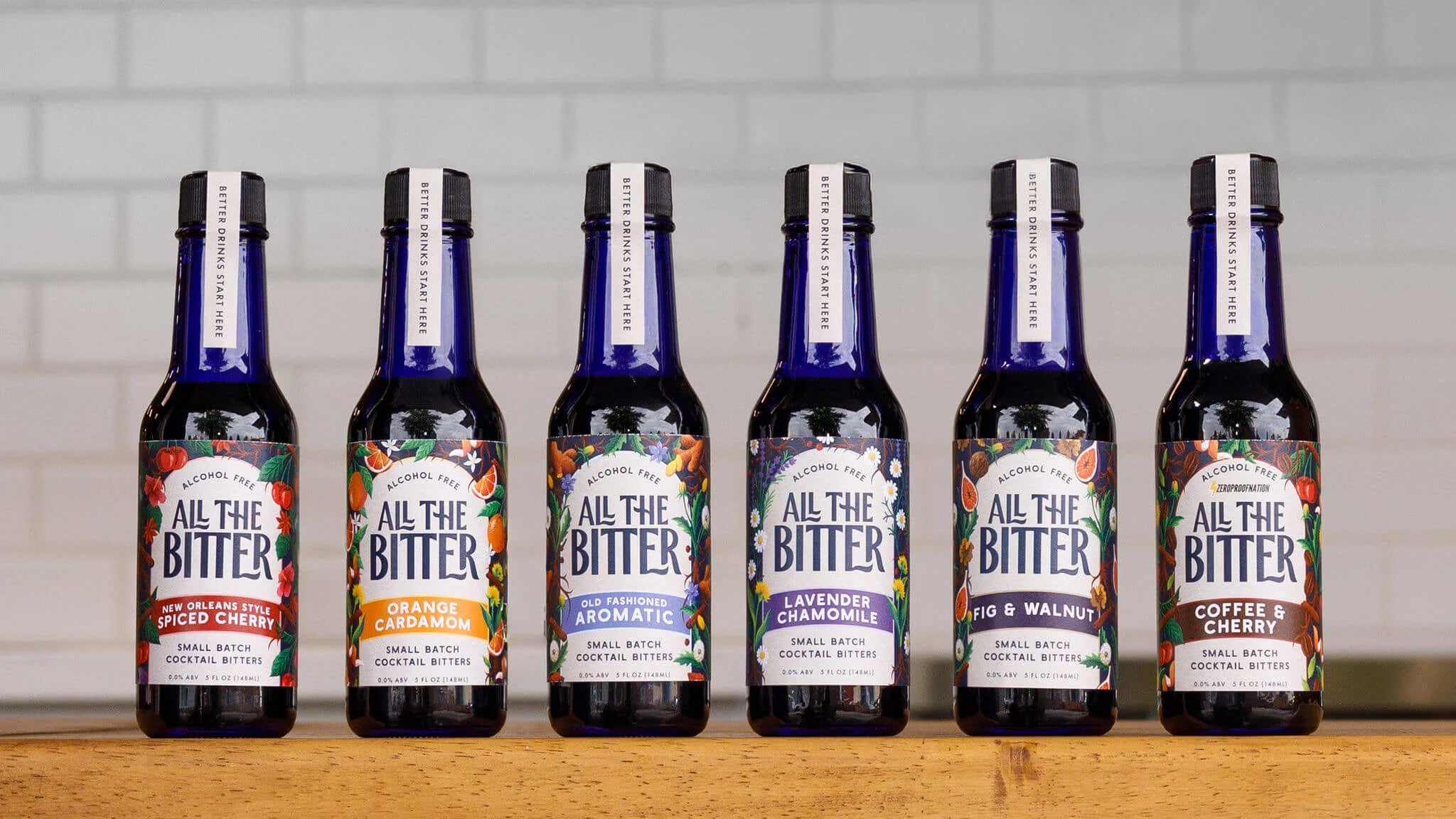 Row of All The Bitter non alcoholic bitters lined up on a bar.