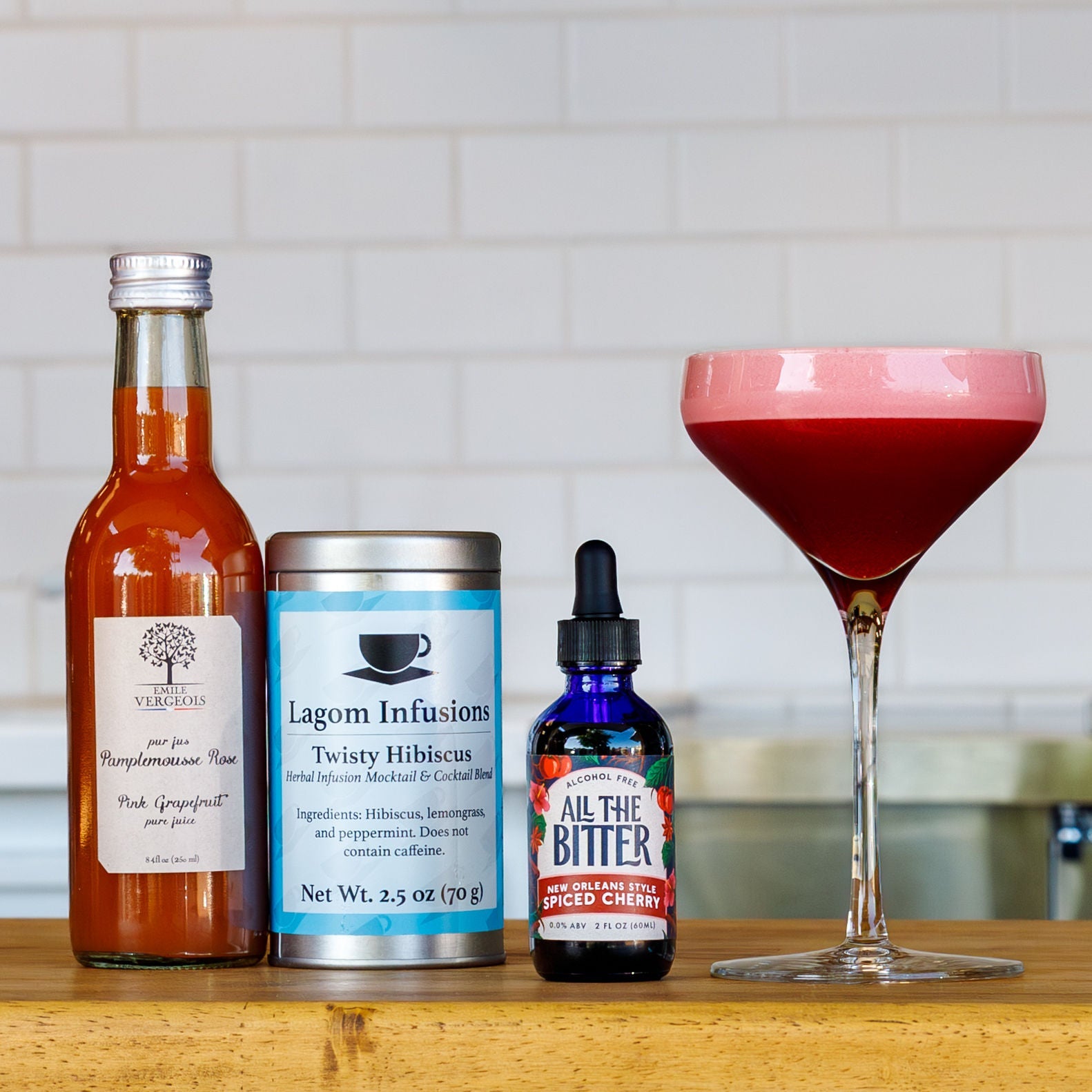 Hibiscus sour mocktail with grapefruit juice, hibiscus tea, and spiced cherry bitters