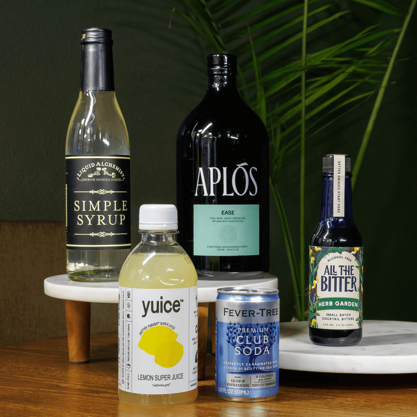 Photo of the contents of the Garden Collins mocktail kit, including Aplos Ease and All The Bitter Herb Garden bitters.
