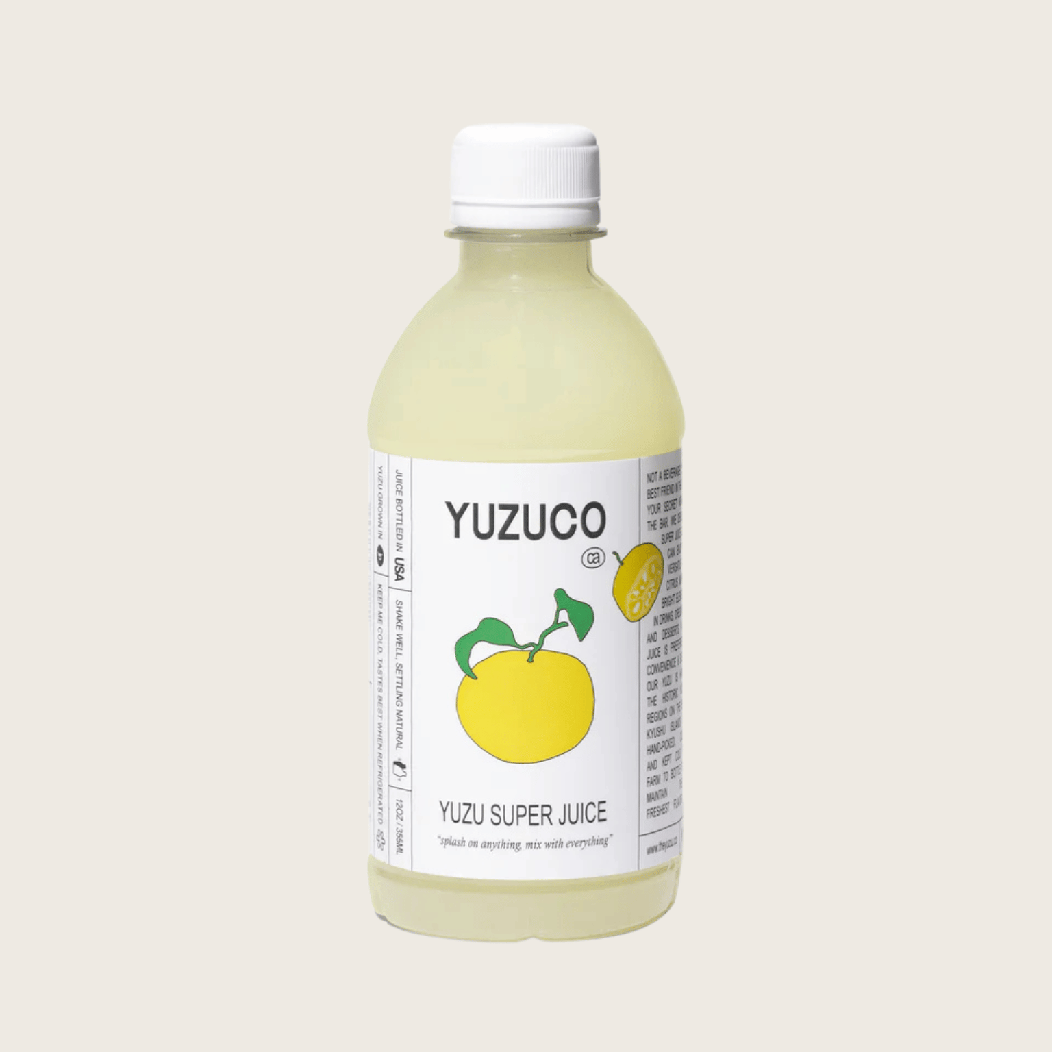 Bottle of Yuzuco Yuzu Super Juice on a light beige background style=